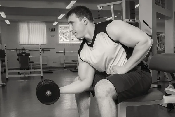 Man makes exercises with dumbbells. — Stock Photo, Image