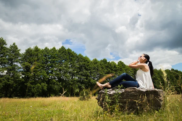 Woman on stone — Stock Photo, Image