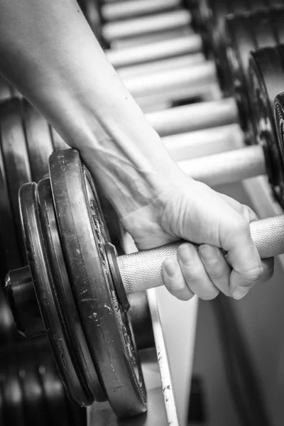 Muscular arm in the gym. — Stock Photo, Image