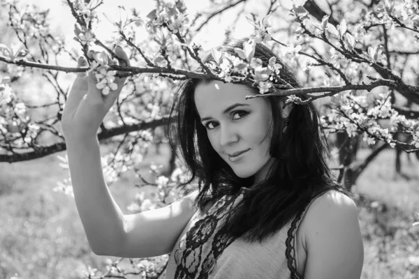 Girl near a flowering tree — Stock Photo, Image