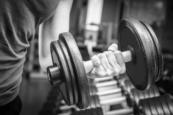 Muscular arm in the gym. — Stock Photo, Image