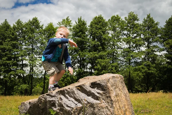 Boy playing on stone — Stock Photo, Image