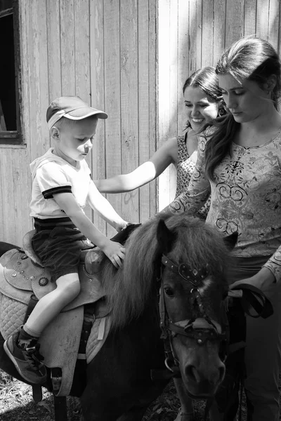 Little boy riding pony — Stock Photo, Image