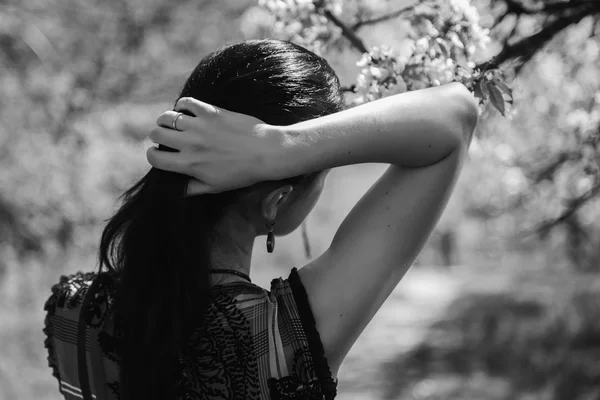 Girl near a flowering tree — Stock Photo, Image