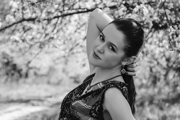 Girl near a flowering tree — Stock Photo, Image