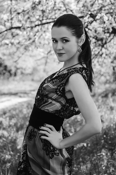 Girl near a flowering tree — Stock Photo, Image