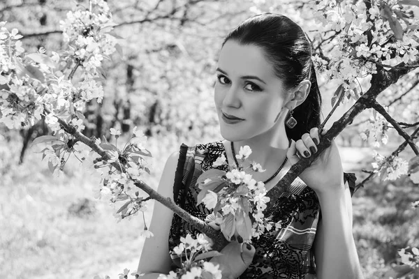 Girl near a flowering tree — Stock Photo, Image