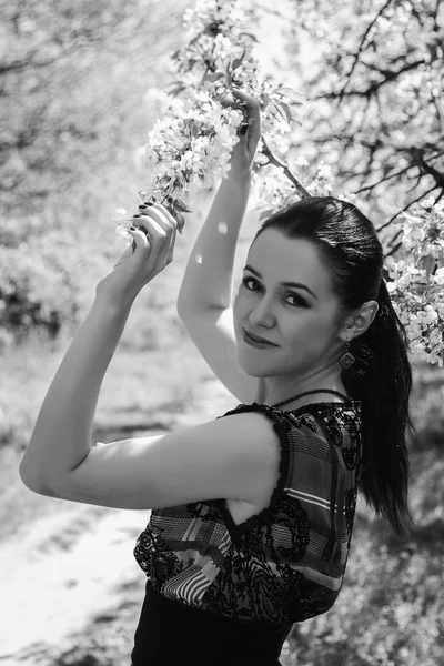 Girl near a flowering tree — Stock Photo, Image