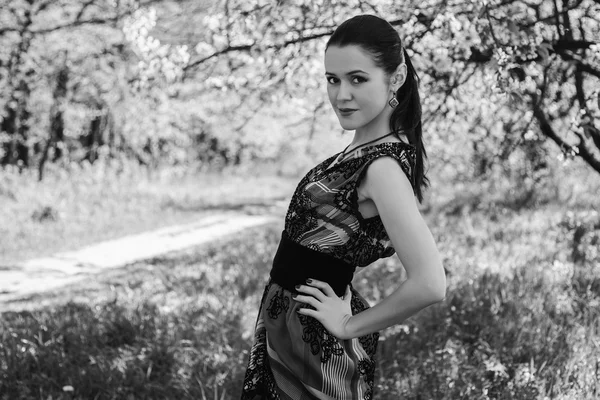 Girl near a flowering tree — Stock Photo, Image