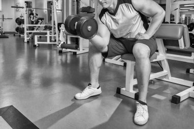 adam dumbbells ile çalışmaları yapan.