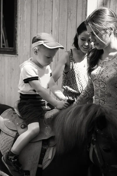 Little boy riding pony — Stock Photo, Image