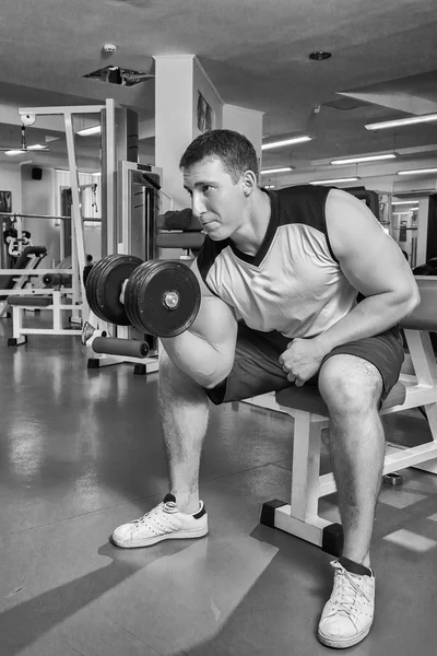 Man makes exercises with dumbbells. — Stock Photo, Image