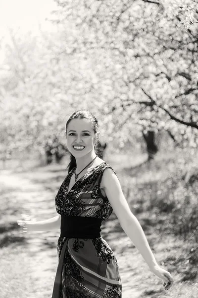 Girl near a flowering tree — Stock Photo, Image