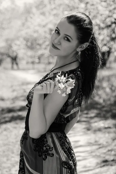 Girl near a flowering tree — Stock Photo, Image