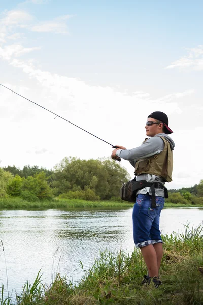 Fisherman on the river bank. — Stock Photo, Image