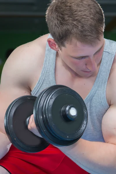 Man makes exercises with dumbbells. — Stock Photo, Image