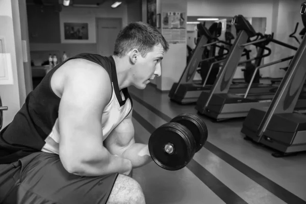 Man makes exercises with dumbbells — Stock Photo, Image