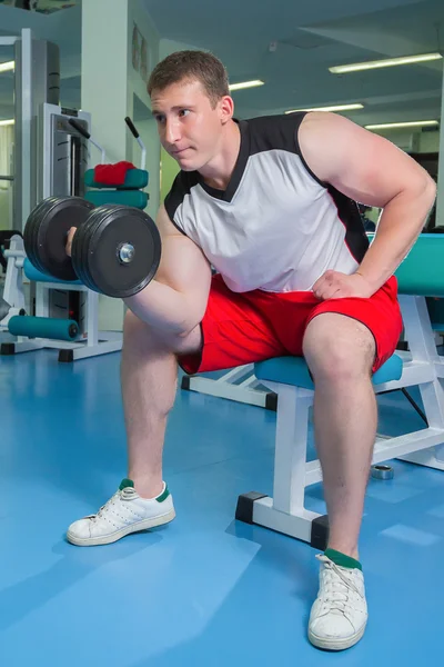 Man makes exercises with dumbbells — Stock Photo, Image