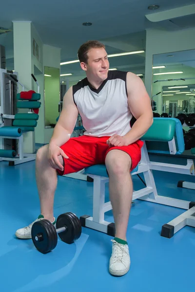 Man makes exercises with dumbbells — Stock Photo, Image