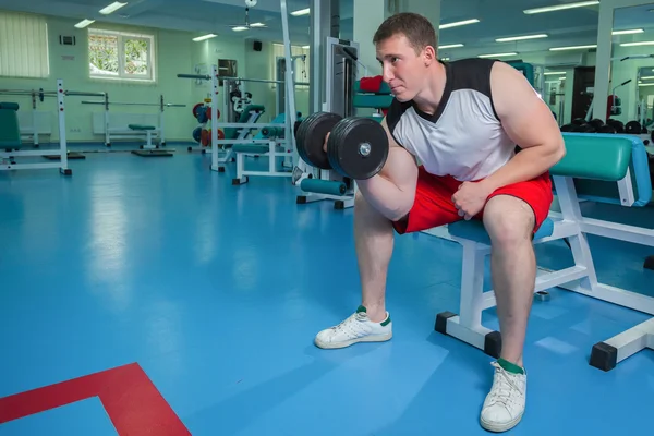 Man makes exercises with dumbbells — Stock Photo, Image