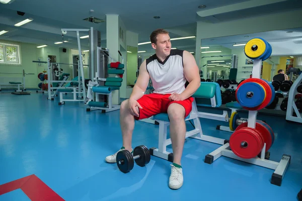 Man makes exercises with dumbbells — Stock Photo, Image