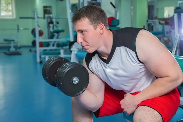 Man makes exercises with dumbbells — Stock Photo, Image