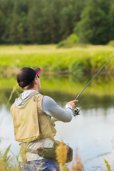 Fisherman on the river bank. — Stock Photo, Image