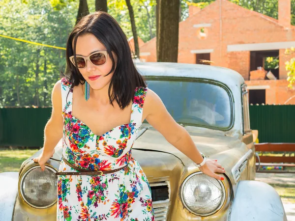 Brunette vrouw in de buurt van oldtimers — Stockfoto