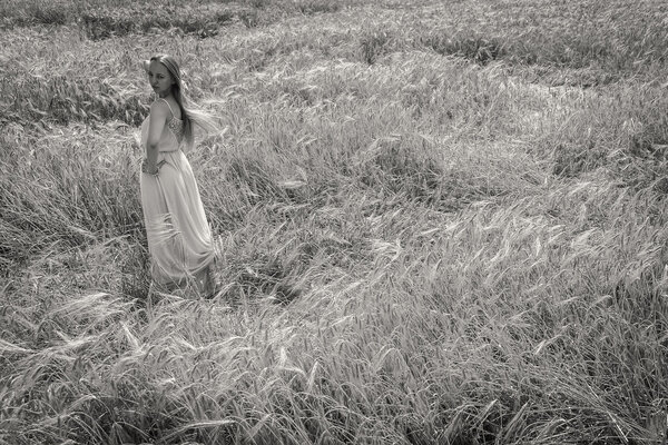 Black and white portrait of a beautiful blonde woman in the summer field