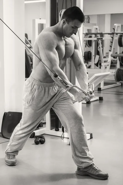 Muskulöser Mann, der mit Gewichten trainiert — Stockfoto