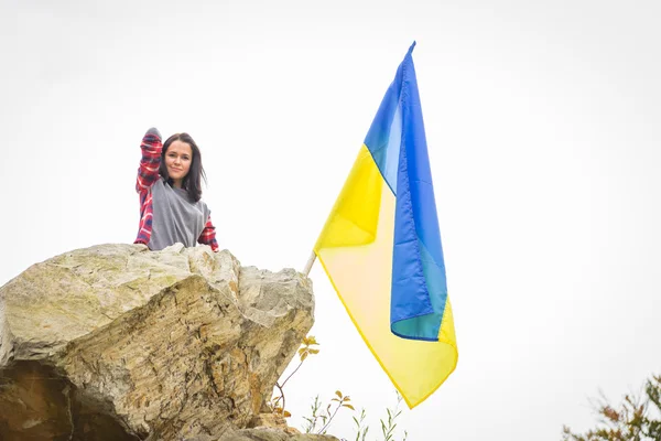 Mujer en la cima de la montaña con bandera ucraniana — Foto de Stock