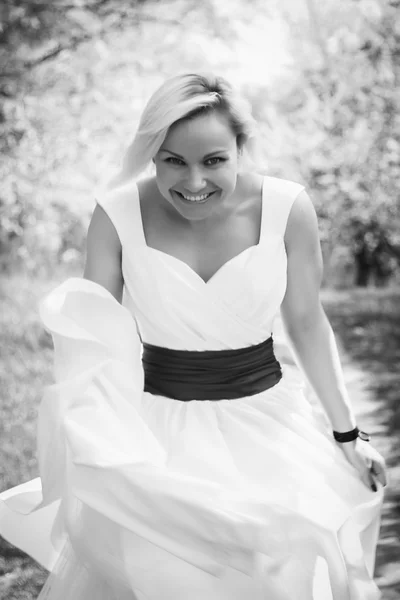 Blonde in white dress in spring garden — Stock Photo, Image