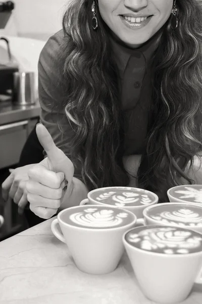 Woman with seven cups of cappuccino — Stock Photo, Image