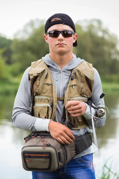 Fisherman on the river bank — Stock Photo, Image