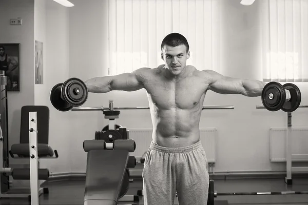 Muscular man working out with dumbbells — Stock Photo, Image