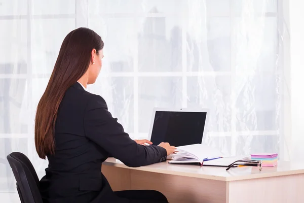 Zakenvrouw met laptop in het kantoor — Stockfoto