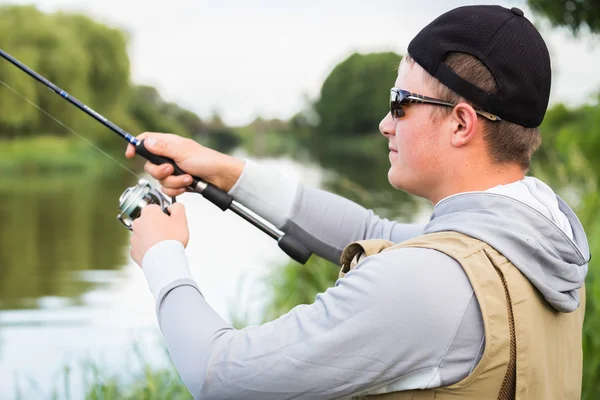 Fisherman on the river bank — Stock Photo, Image