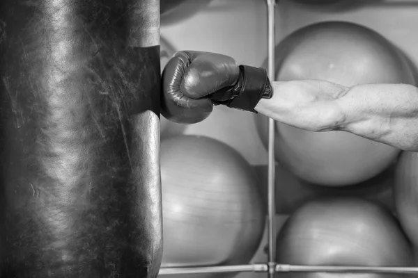 Man in boxing gloves hit a punching bag — Stock Photo, Image