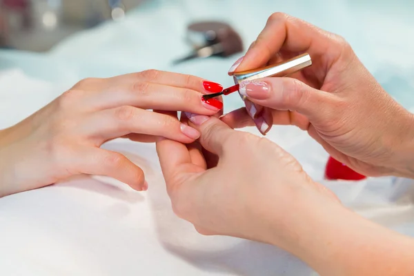 Woman applying nail varnish to nails — Stock Photo, Image