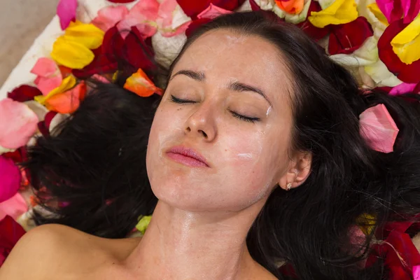 Young woman receiving facial mask