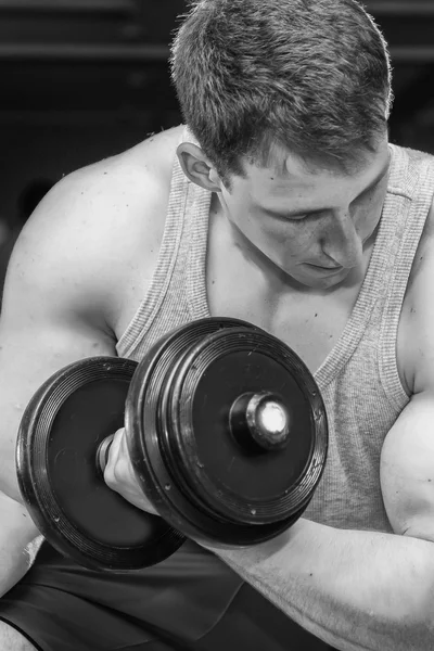 Man holding dumbbell in suspense — Stock Photo, Image