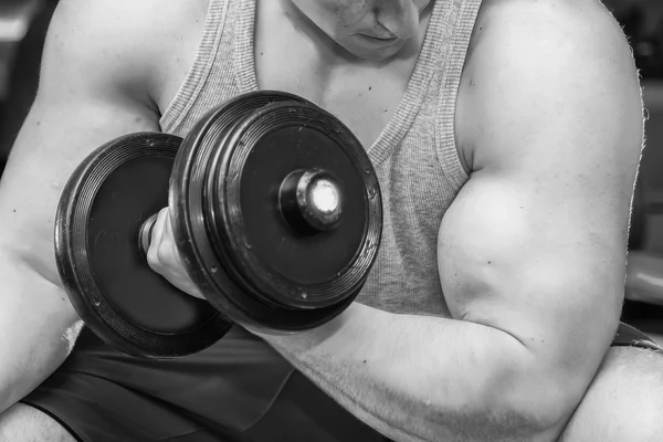 Man holding dumbbell in suspense — Stock Photo, Image