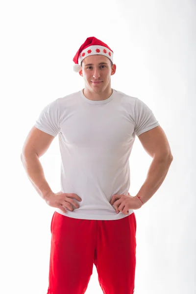 Athletic man in a Christmas hat — Stock Photo, Image