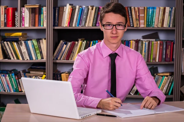 Student werkt in een bibliotheek — Stockfoto