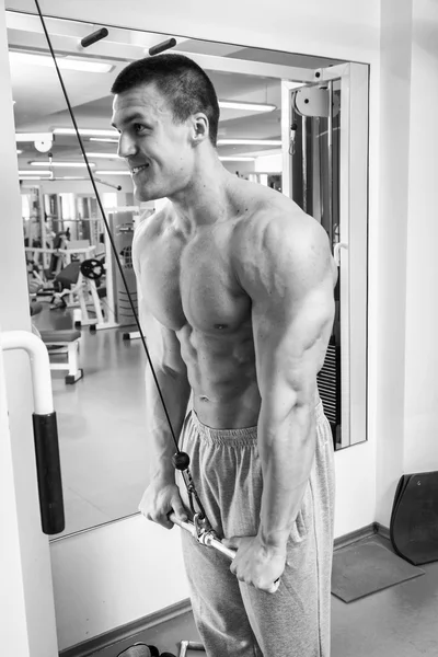 Muscular man working out with weights — Stock Photo, Image