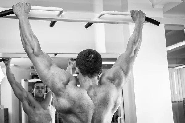 Muscular man working out with weights