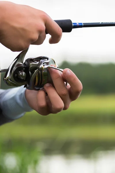 Fisherman with a fishing rod — Stock Photo, Image