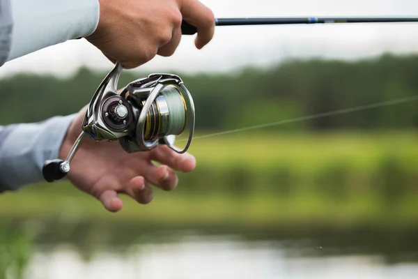 Fisherman with a fishing rod — Stock Photo, Image