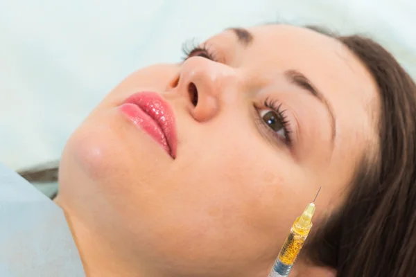 Beautician makes injection into the patient's face — Stock Photo, Image