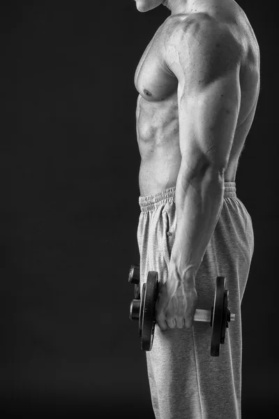 Man makes exercises dumbbells — Stock Photo, Image